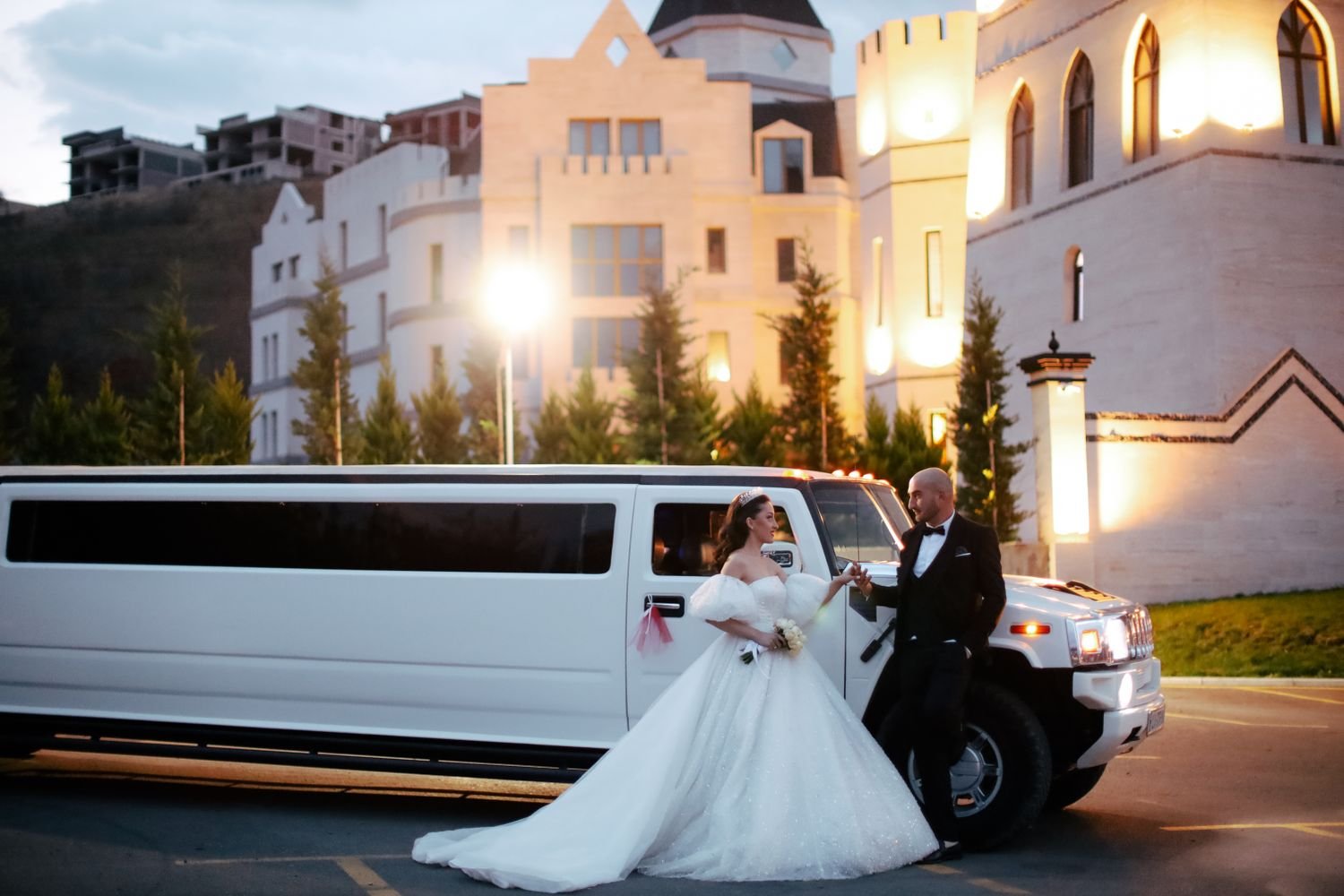 White limousine with chauffeur waiting