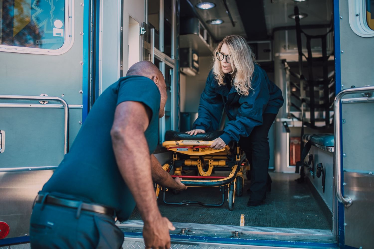 Wheelchair-accessible NEMT van with lift deployed