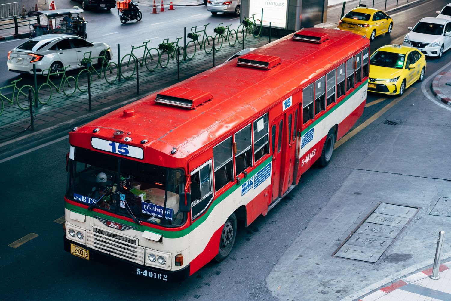 Passengers boarding a white shuttle bus